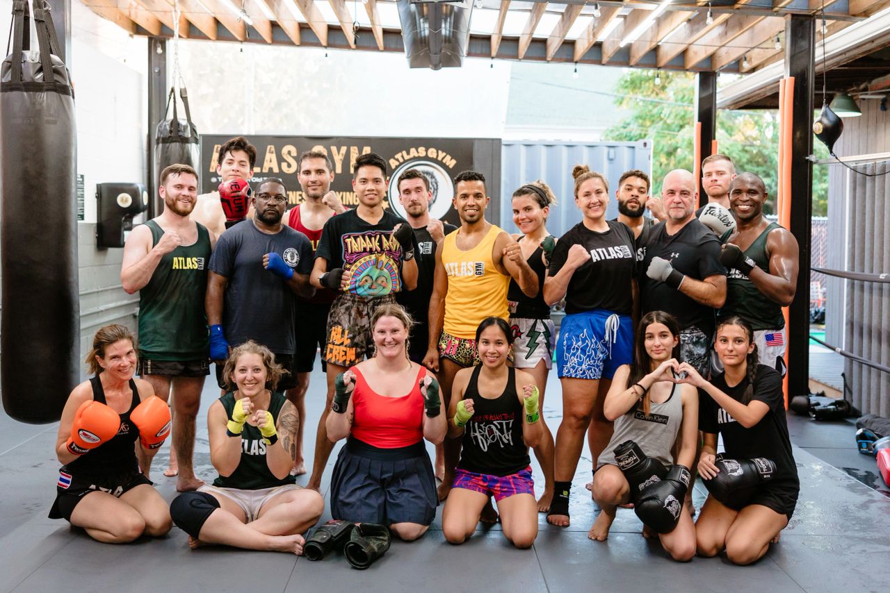 Atlas Muay Thai students posing together after training, from the original 2023 article